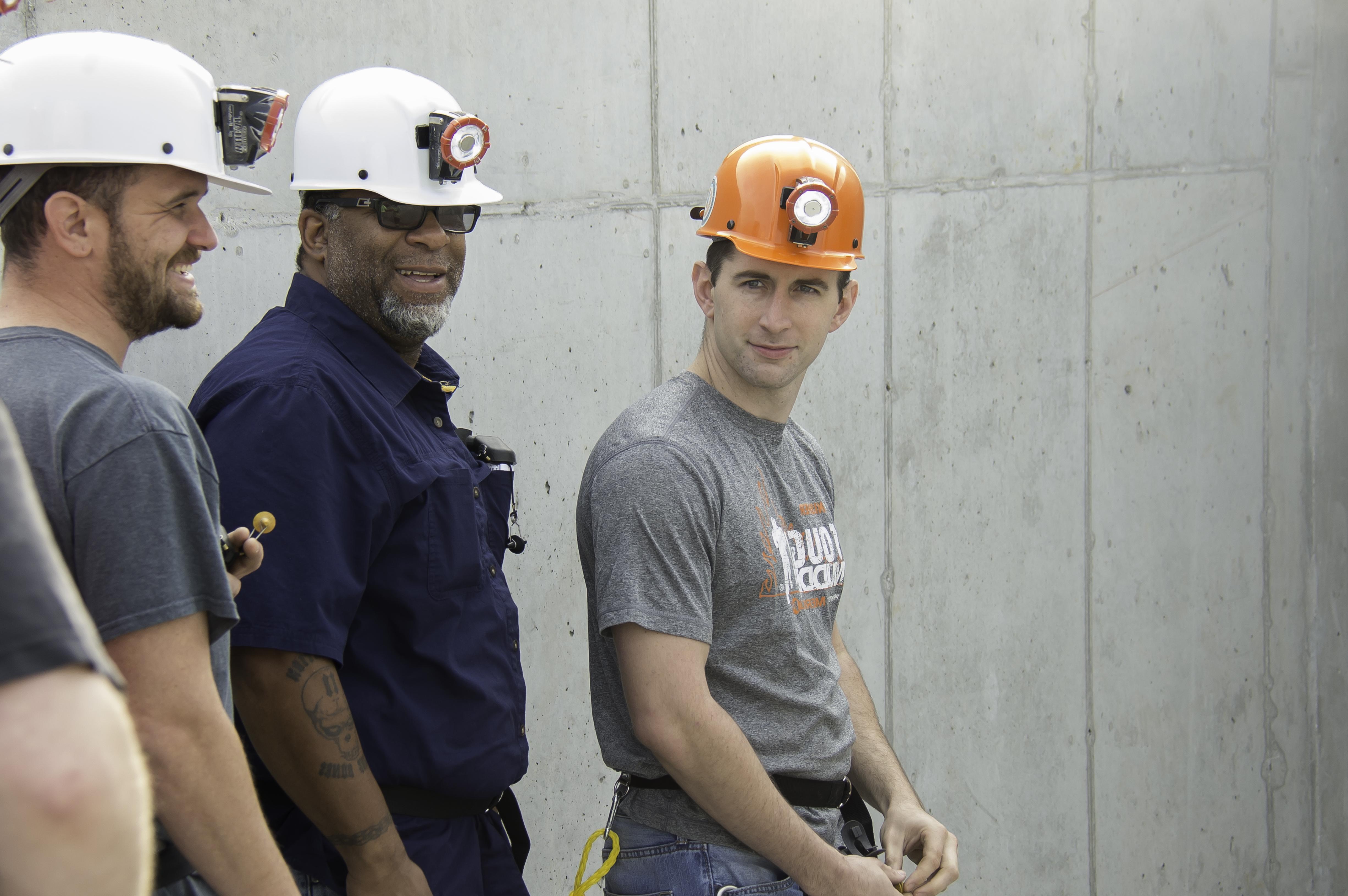 Three men wearing hard hats